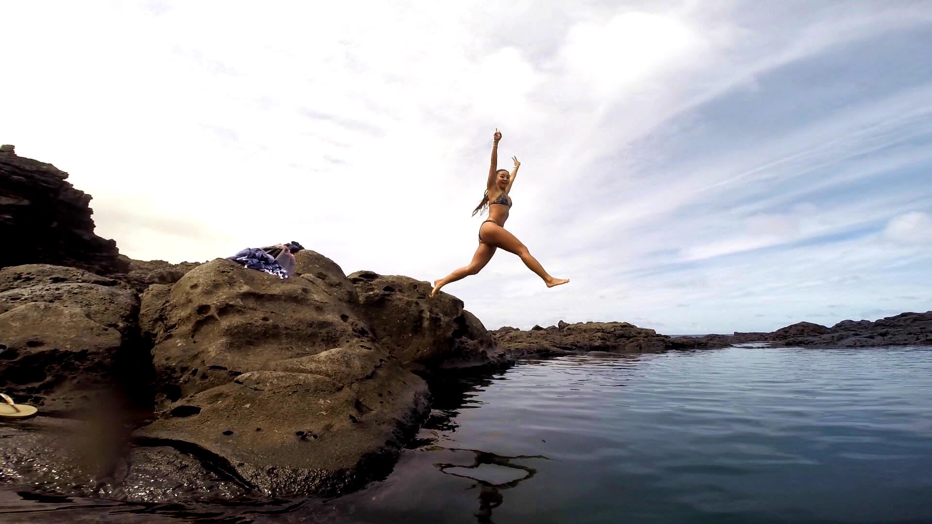 In action shot jumping into the tide pools in Maui